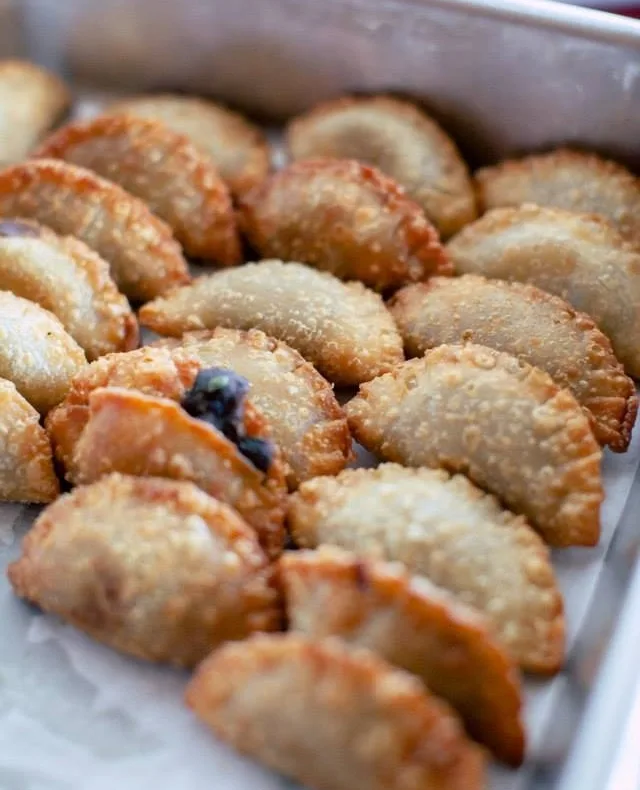 a catered affair nashville wedding empanadas private event catering - Nashville Private Event Catering Golden baked empanadas with fruit fillings displayed in white serving tray by Nashville wedding caterer A Catered Affair for private event