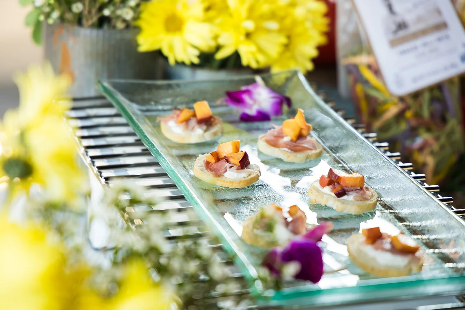 Elegant wedding appetizers with colorful garnishes beautifully presented on glass serving tray by A Catered Affair Nashville wedding caterer