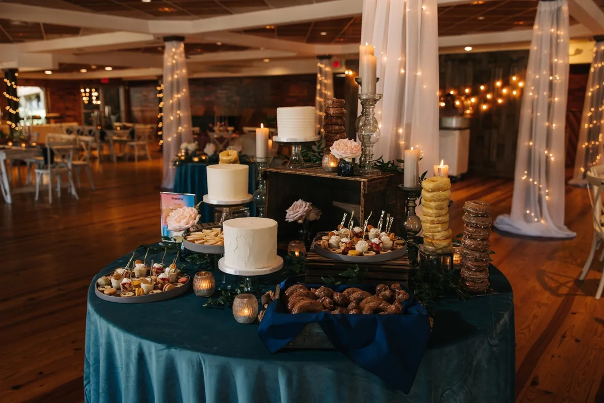 elegant wedding dessert table candles navy linens nashville - Desserts Elegant wedding dessert table with white cakes, candles, and navy blue linens at Nashville wedding venue by A Catered Affair
