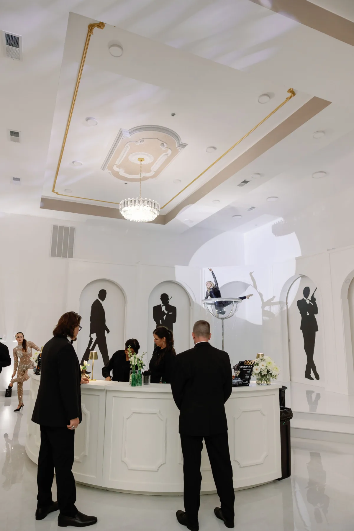 Elegant white wedding reception bar with formal guests at luxury Nashville venue featuring ornate ceiling details and sophisticated lighting
