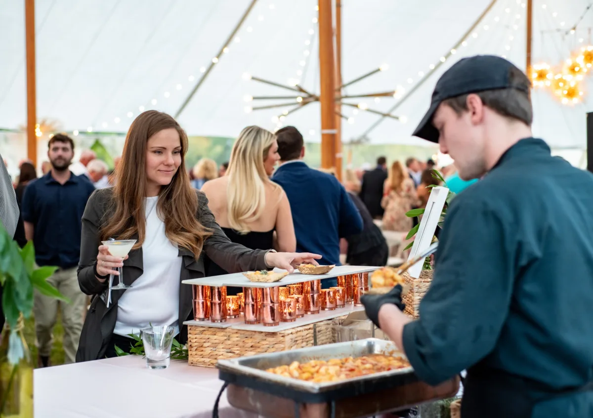 Professional catering service by A Catered Affair serving guests at elegant Nashville corporate event with copper chafing dishes and buffet setup