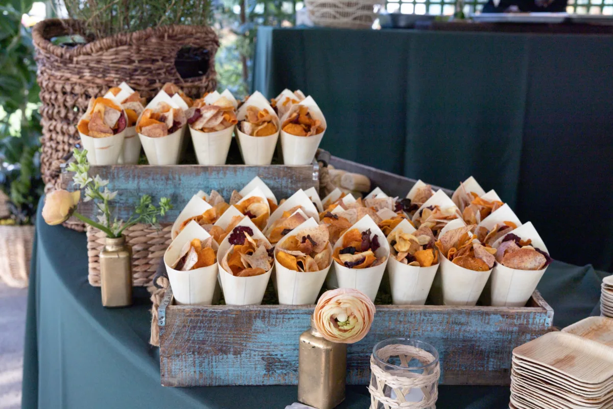 Rustic wooden crates display gourmet vegetable chips in paper cones for Nashville corporate event catering by A Catered Affair