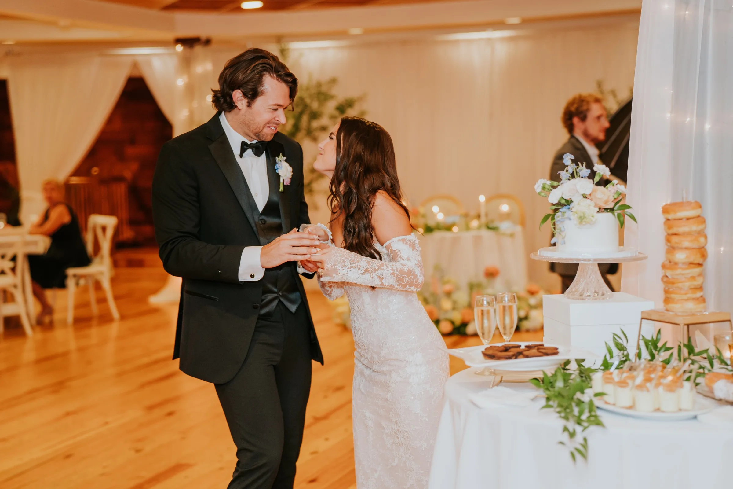 nashville wedding cake cutting ceremony a catered affair - Nashville Wedding Catering Bride and groom cutting wedding cake at elegant Nashville reception catered by A Catered Affair