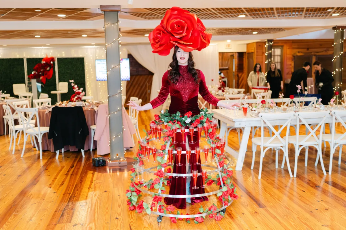 A Catered Affair Nashville wedding caterer provides elegant champagne service with rose-themed entertainment performer at wedding reception