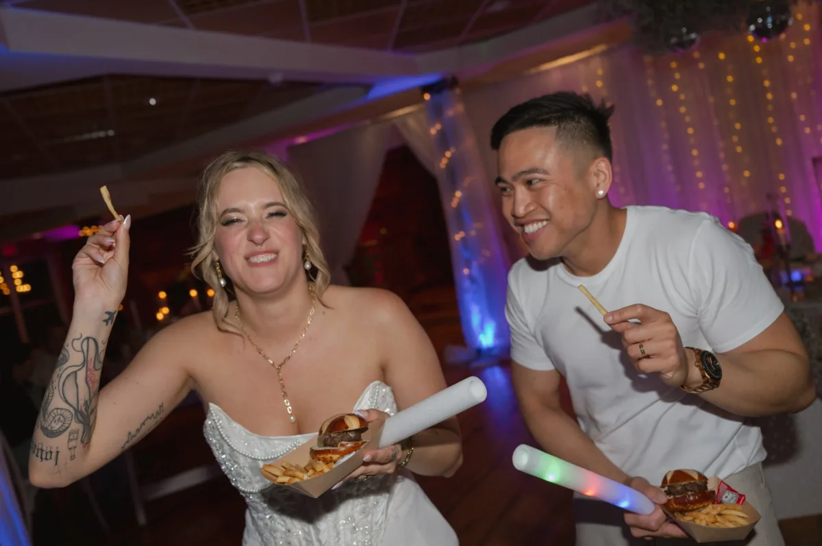 Bride and groom enjoying late night wedding catering with sliders and fries from Nashville caterer A Catered Affair