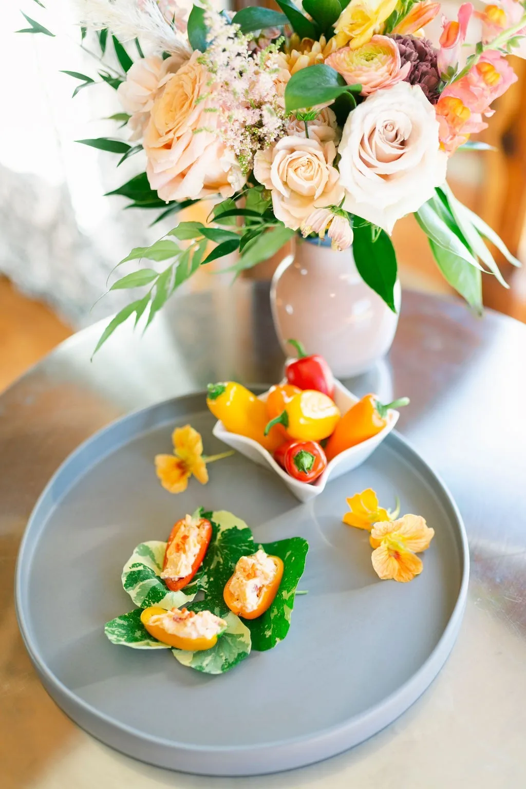 nashville wedding catering appetizer display floral centerpiece - About A Catered Affair Elegant wedding appetizer display by A Catered Affair featuring stuffed peppers and fresh salad with romantic floral centerpiece in Nashville