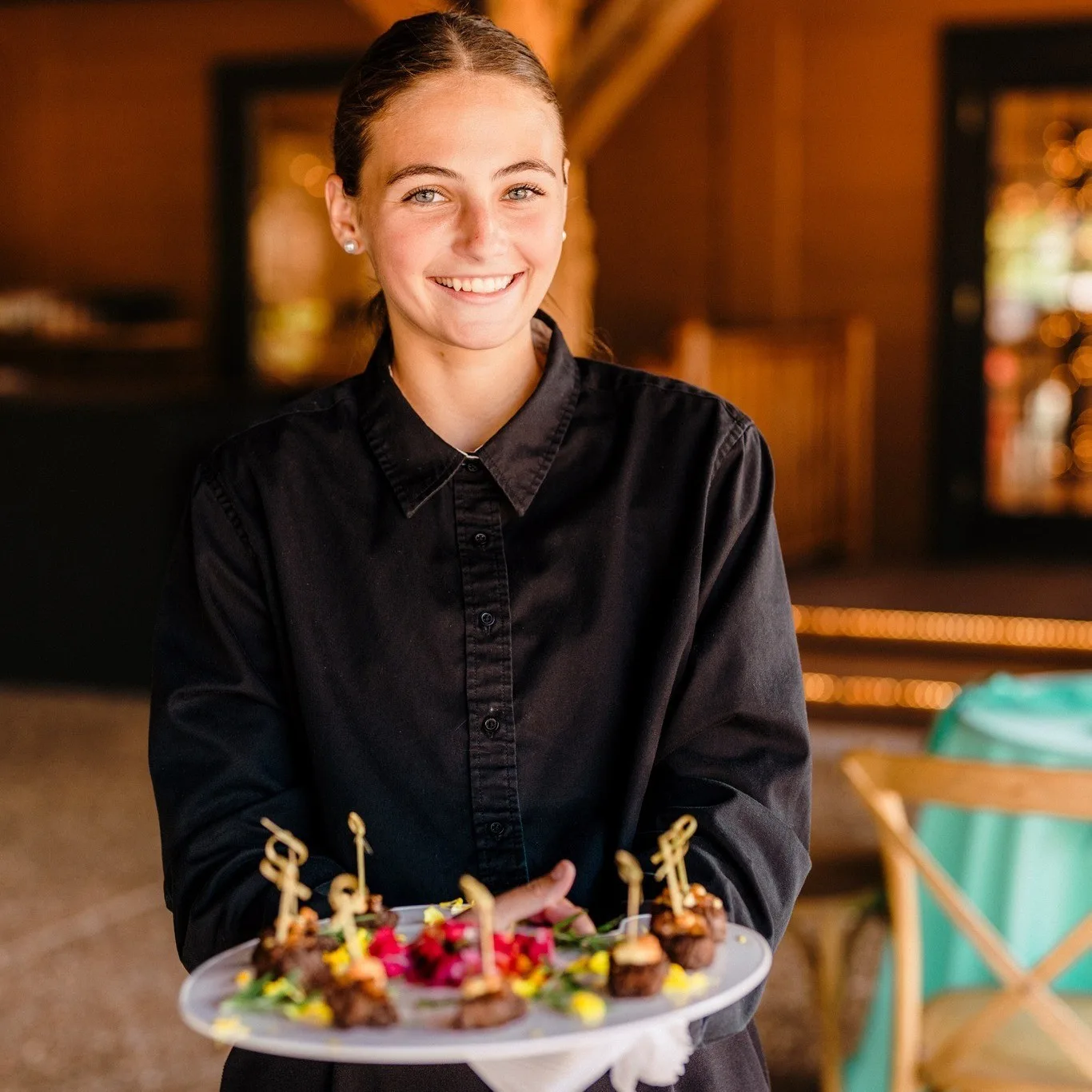 Professional server presenting elegant wedding appetizers at Nashville venue by A Catered Affair catering