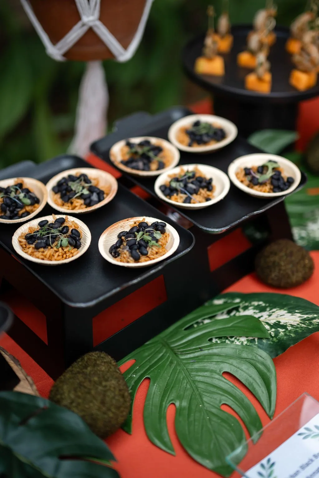 Elegant wedding appetizers with black olives and grains served in wooden boats by Nashville caterer A Catered Affair