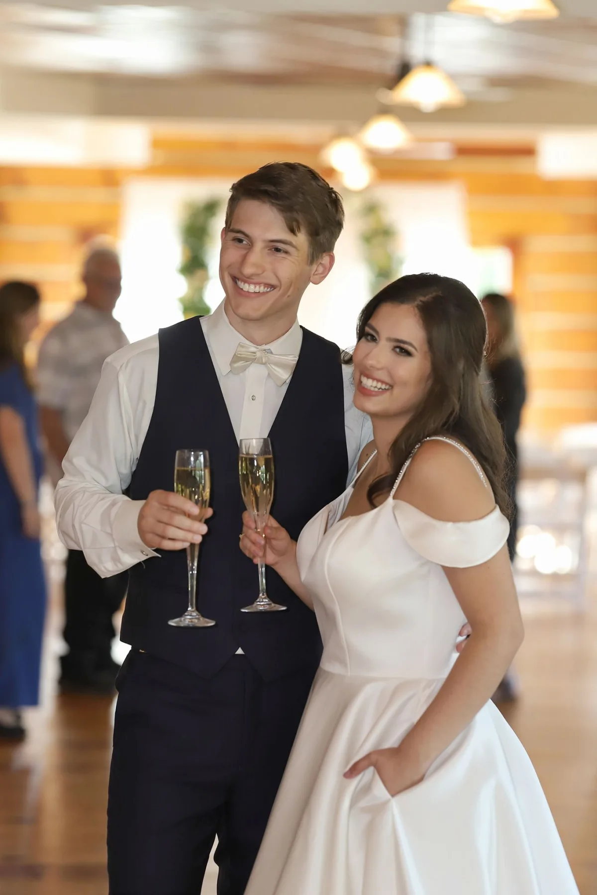 Happy bride and groom toasting with champagne glasses at their Nashville wedding reception catered by A Catered Affair