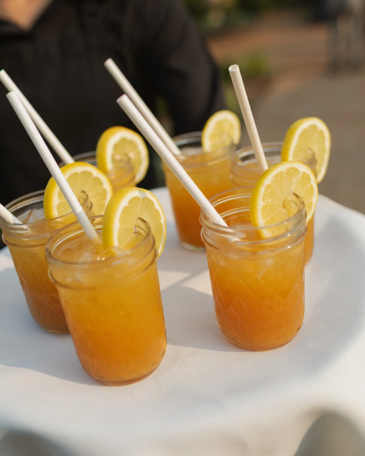 nashville wedding catering citrus cocktails a catered affair - Beverages Orange citrus cocktails with lemon garnish and paper straws served by Nashville wedding caterer A Catered Affair