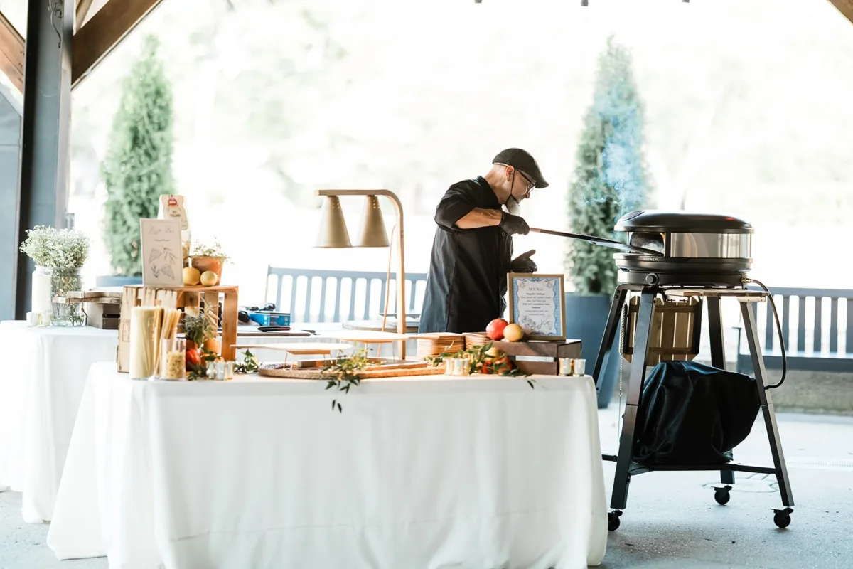 Professional chef from A Catered Affair preparing fresh food at live cooking station during Nashville wedding reception