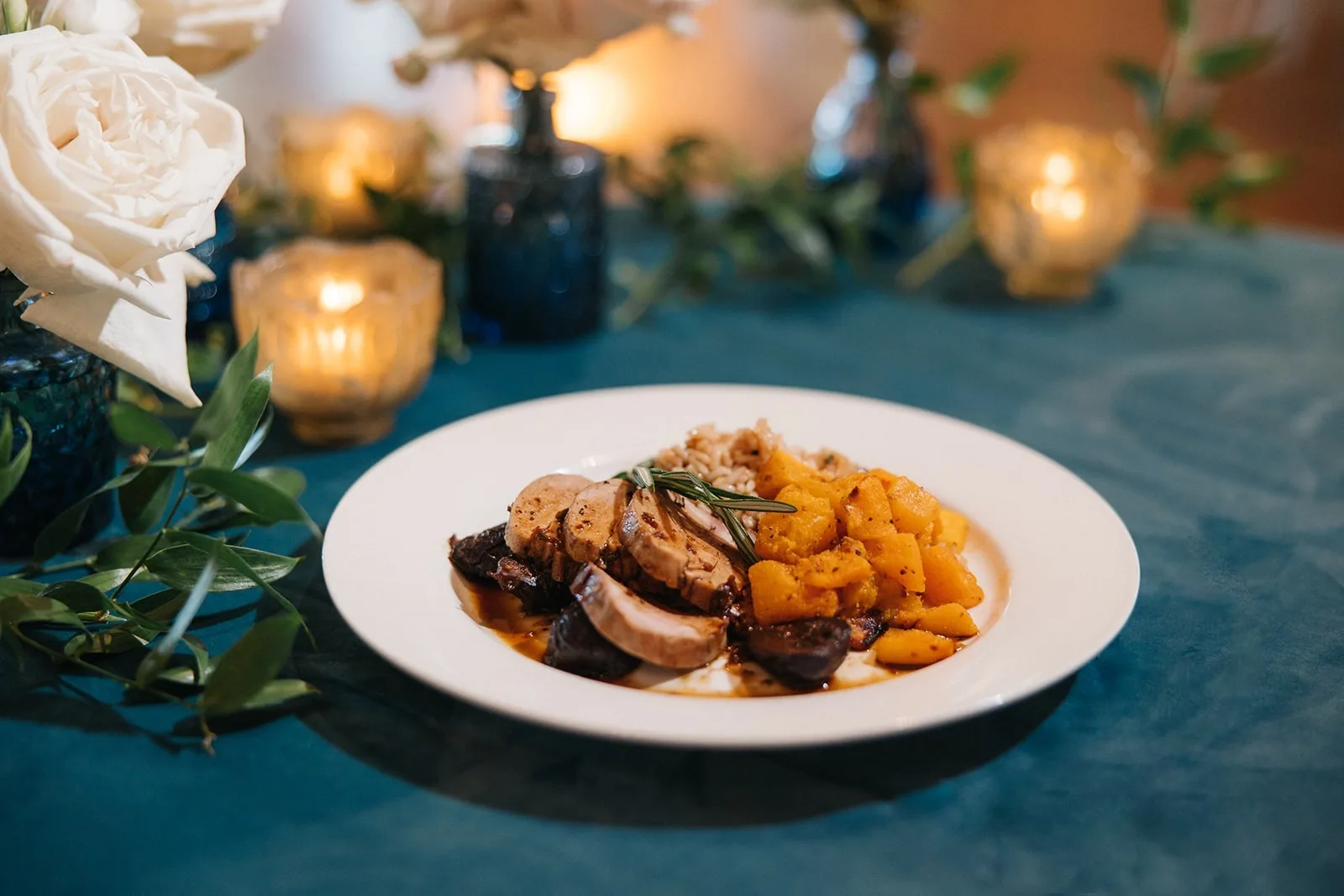 Elegant plated wedding dinner with sliced meat and roasted vegetables by Nashville caterer A Catered Affair