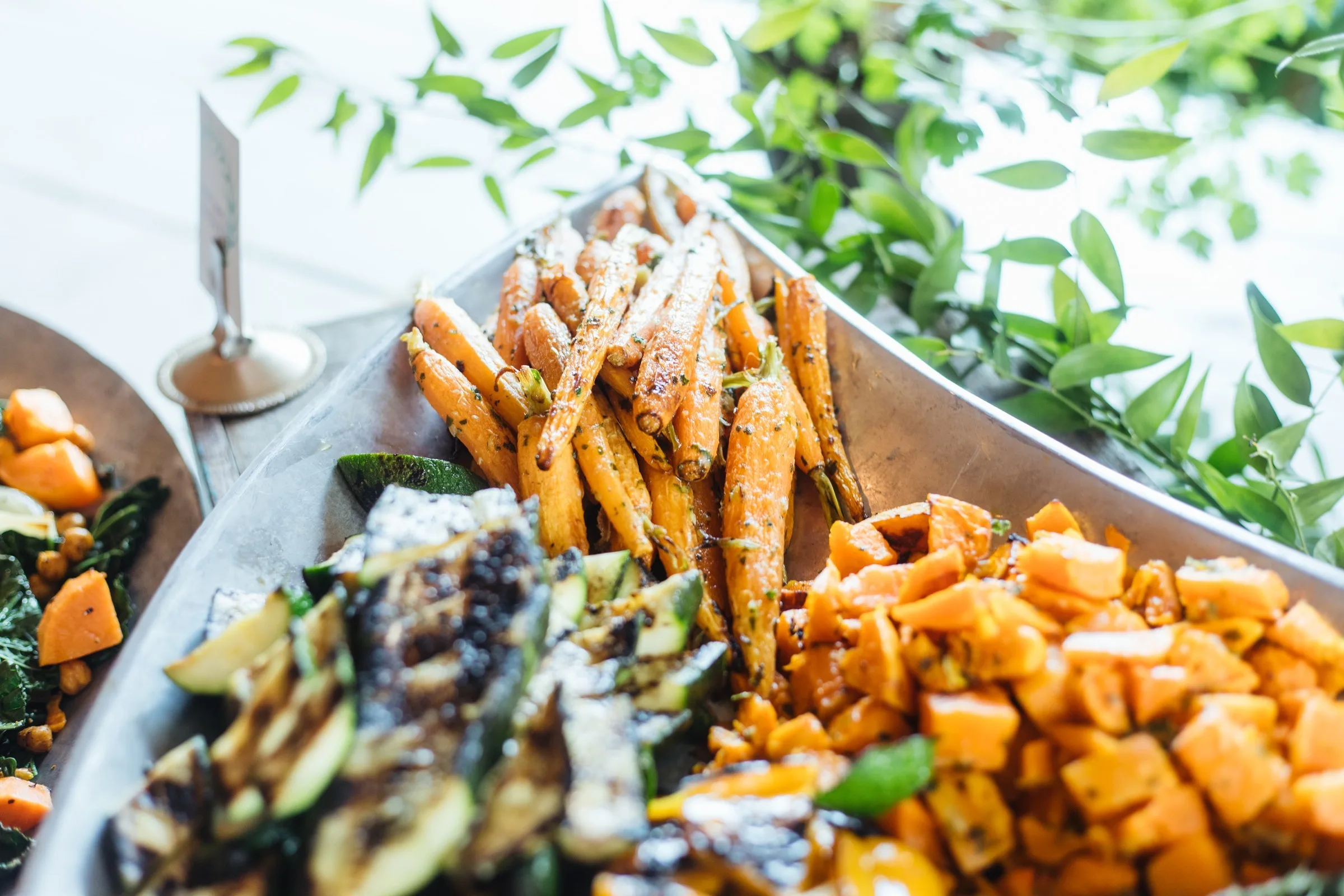 Roasted carrots and seasonal vegetables prepared by Nashville wedding caterer A Catered Affair displayed on metal serving tray