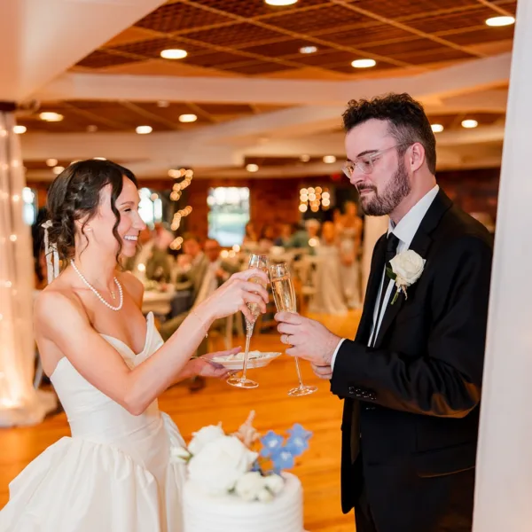 Bride and groom toast with champagne glasses at Nashville wedding reception catered by A Catered Affair