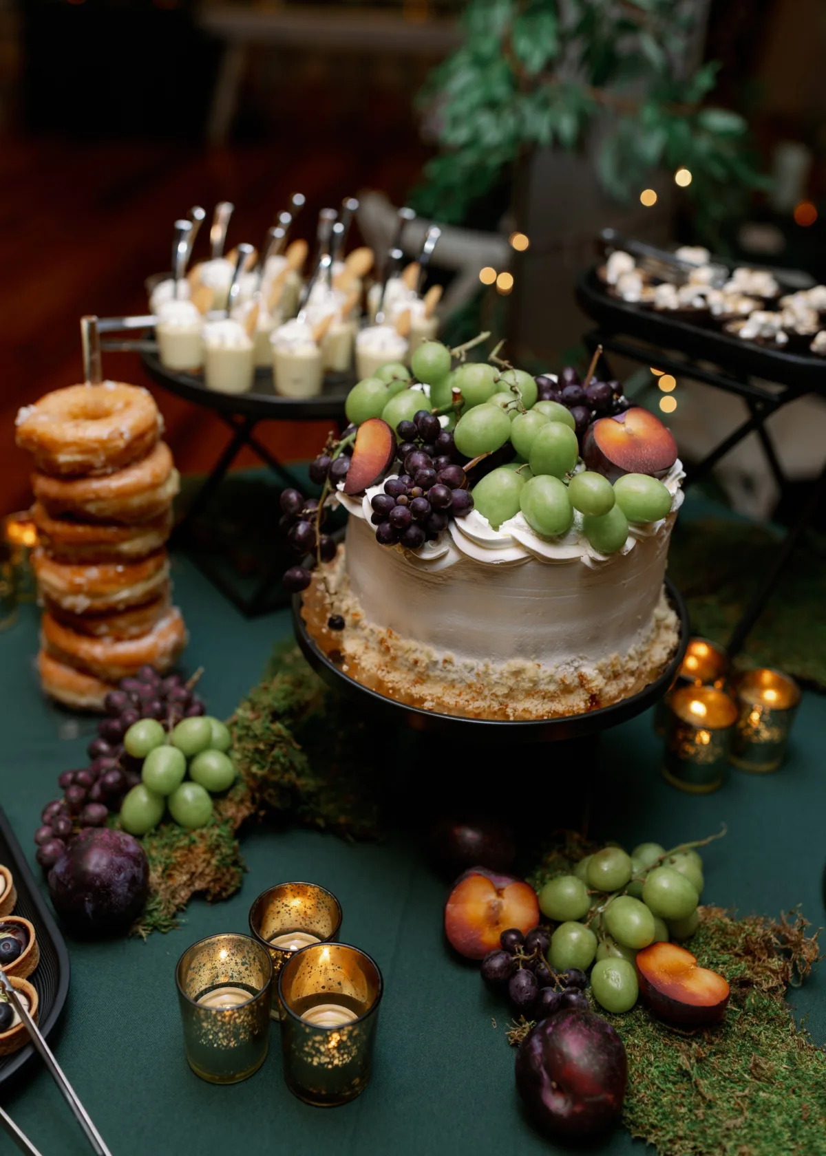 nashville wedding dessert table a catered affair fruit cake - Desserts Elegant wedding dessert table by A Catered Affair featuring fresh fruit topped cake, donuts, and candlelit display in Nashville