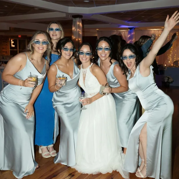 Bride and bridesmaids in matching sunglasses celebrating at Nashville wedding reception catered by A Catered Affair