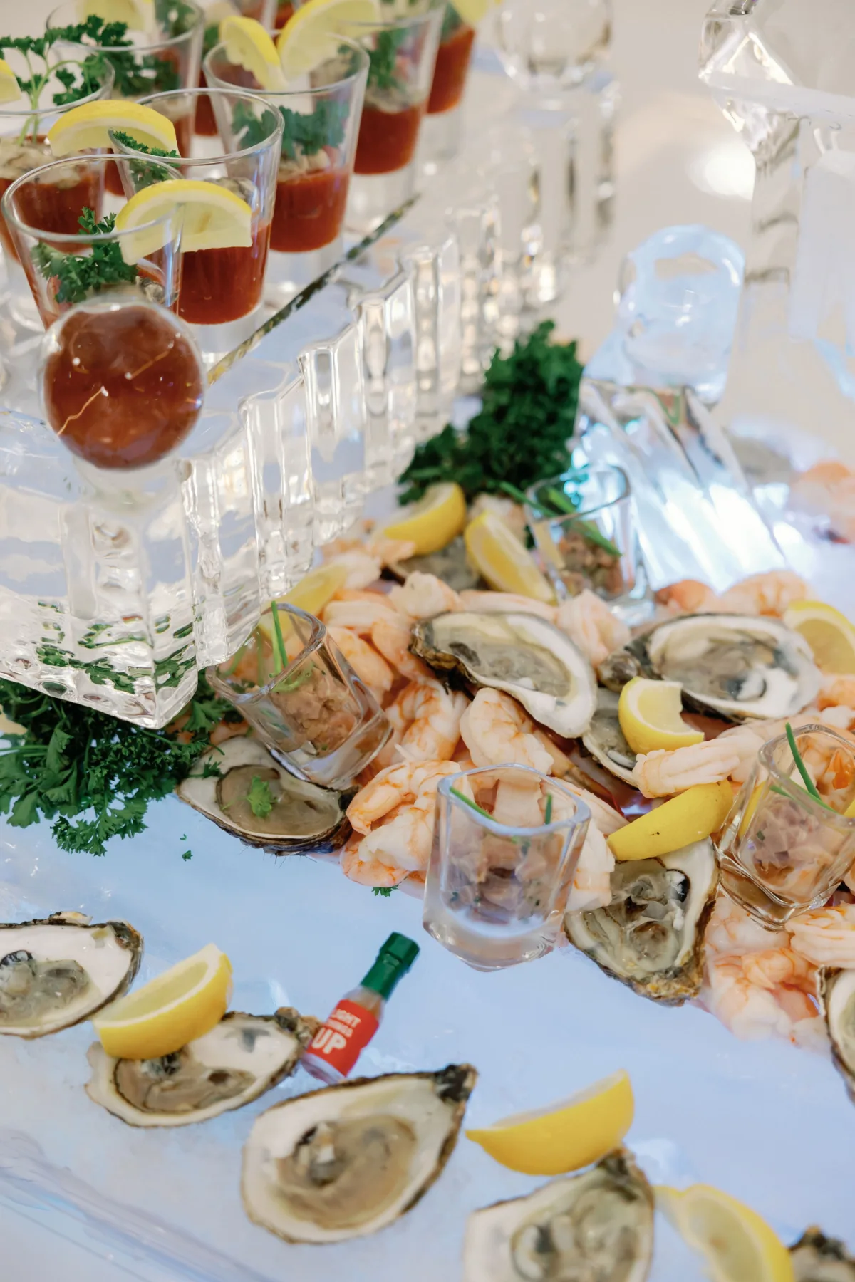 Elegant wedding seafood raw bar with fresh oysters, shrimp, and bloody mary cocktails by Nashville caterer A Catered Affair