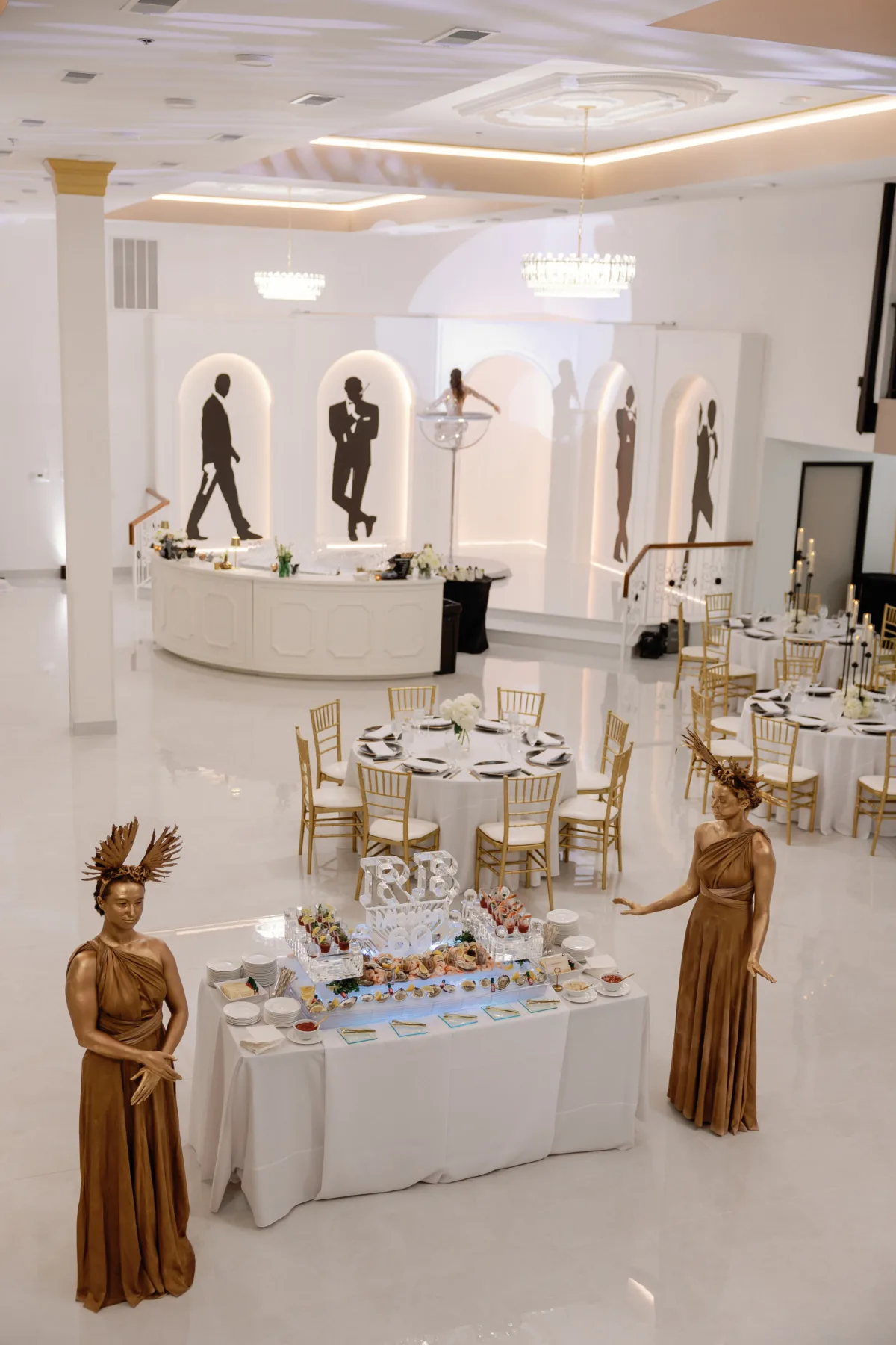 Elegant private event with golden-themed performers and catered appetizer display by A Catered Affair in luxury Nashville venue