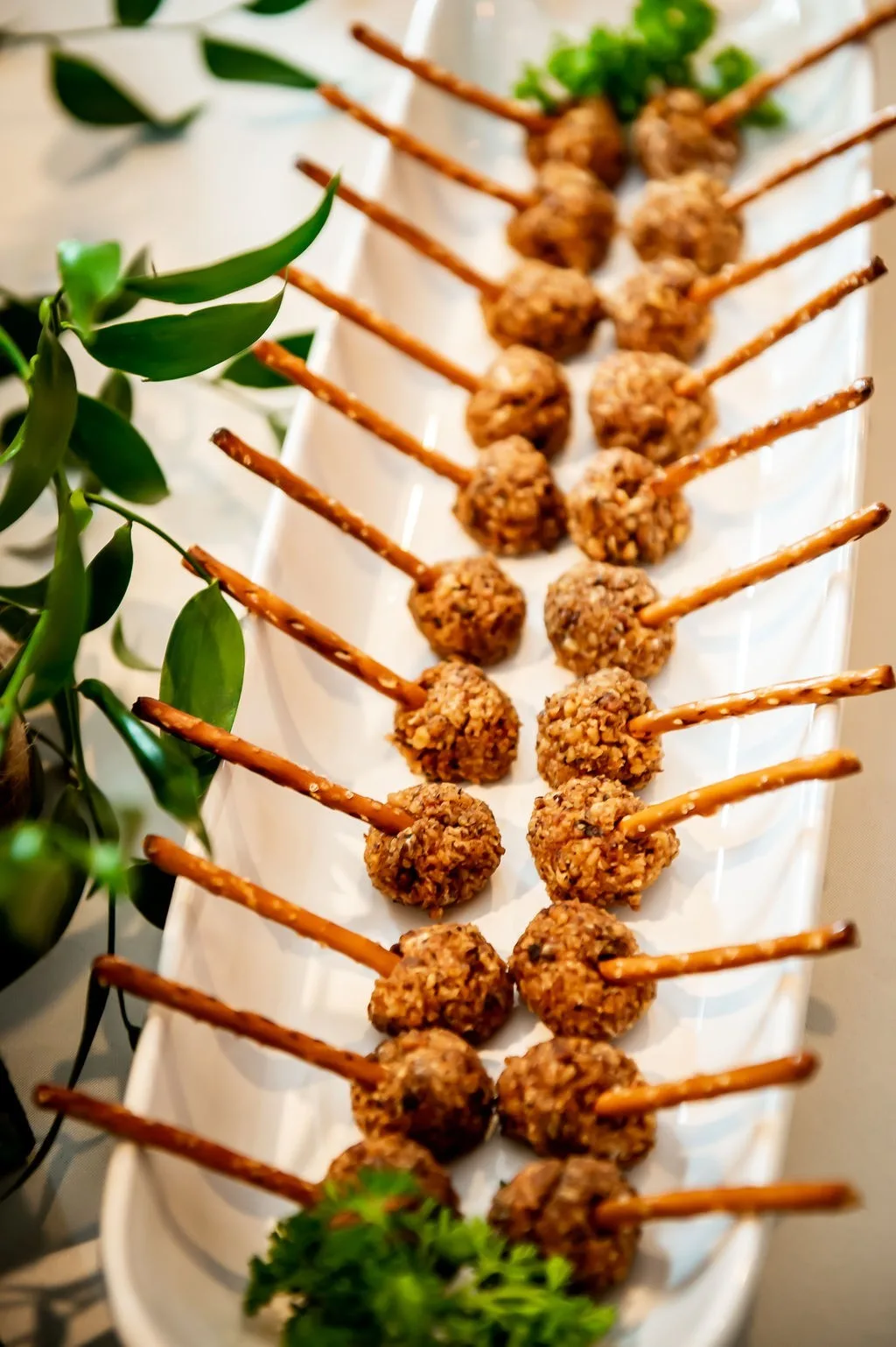 Elegant appetizer skewers with breaded spheres on pretzel sticks created by A Catered Affair for Nashville wedding catering