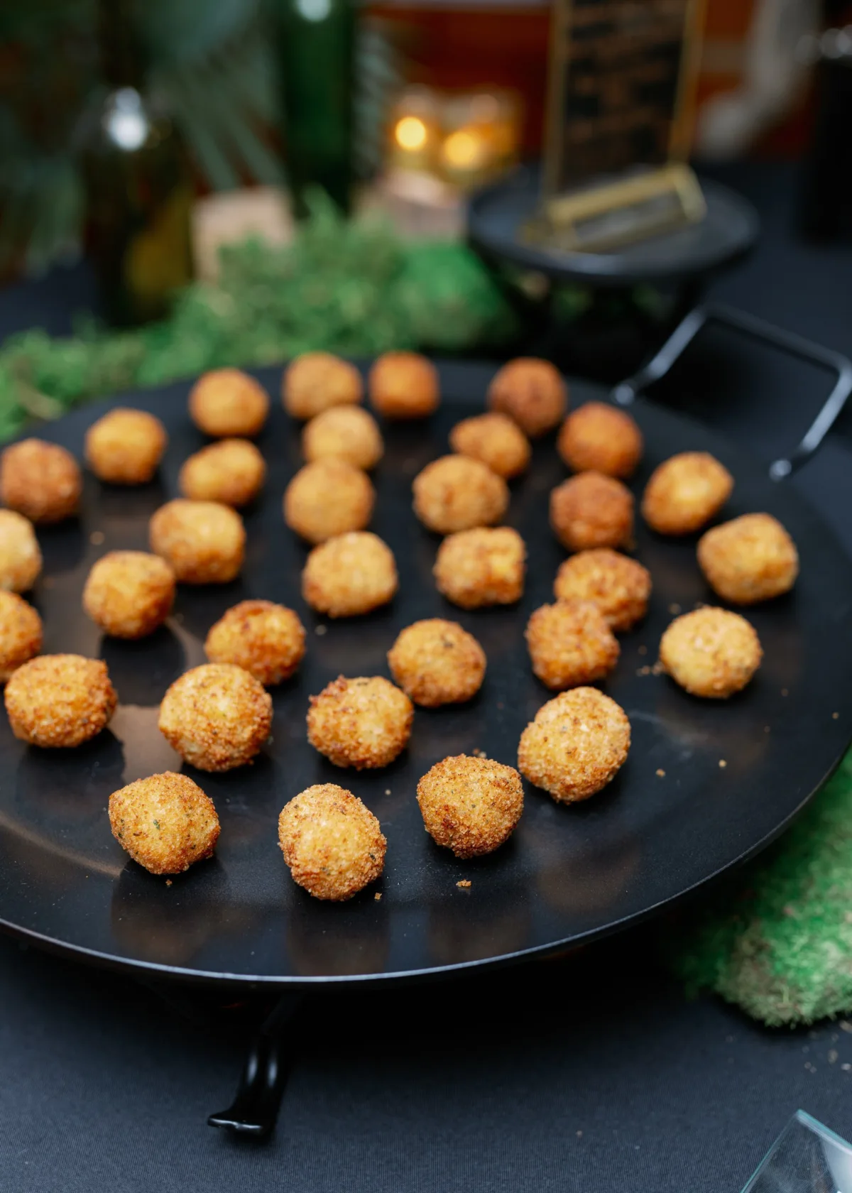 Golden fried appetizer balls served on black plate by A Catered Affair Nashville wedding caterer