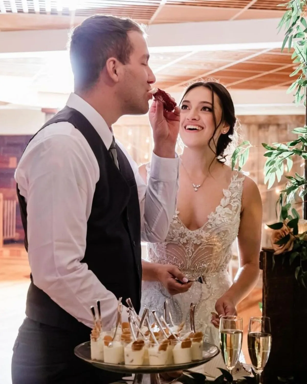 Bride and groom enjoying wedding cake tasting with elegant desserts by A Catered Affair Nashville wedding caterer
