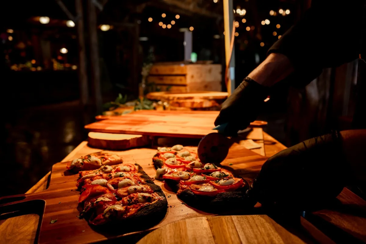 A Catered Affair Nashville wedding caterer serving gourmet pizza at elegant wedding reception food station