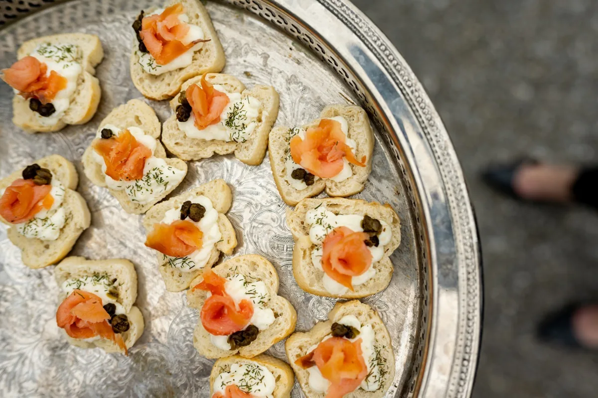 Elegant smoked salmon appetizers with cream cheese and capers on silver tray by A Catered Affair Nashville wedding caterer