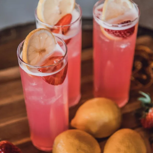 Elegant pink strawberry lemon cocktails with citrus garnish served by A Catered Affair Nashville wedding caterer