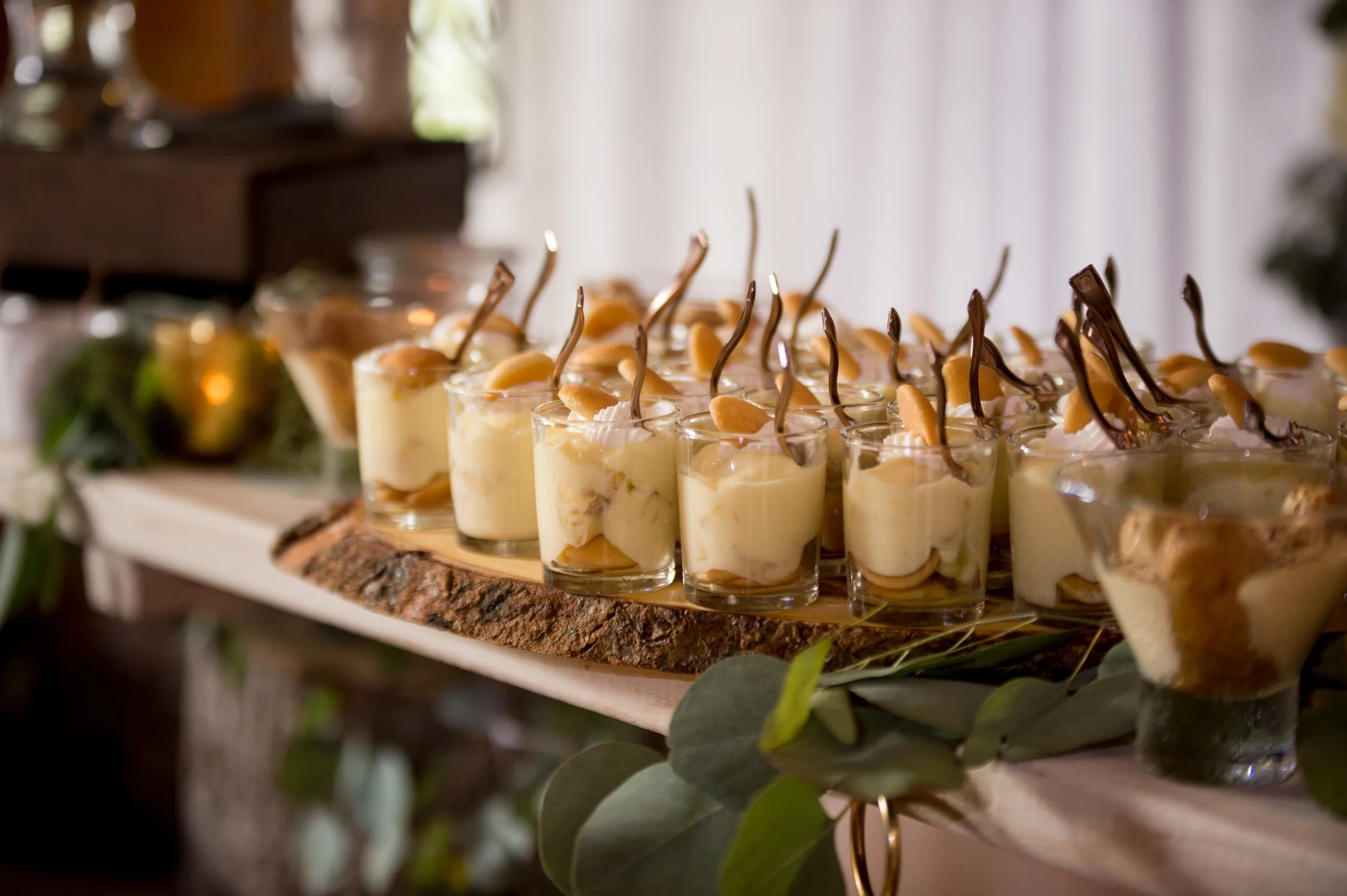 Elegant wedding dessert display with individual glass cups featuring layered treats and chocolate garnishes by A Catered Affair Nashville wedding caterer