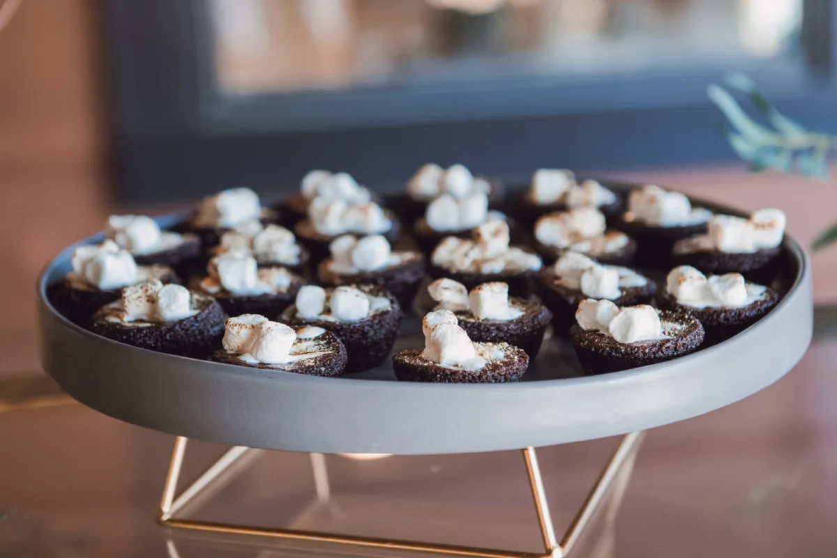 chocolate brownie bites marshmallow dessert table nashville wedding catering - Desserts Chocolate brownie bites topped with mini marshmallows arranged on elegant serving tray by Nashville wedding caterer A Catered Affair