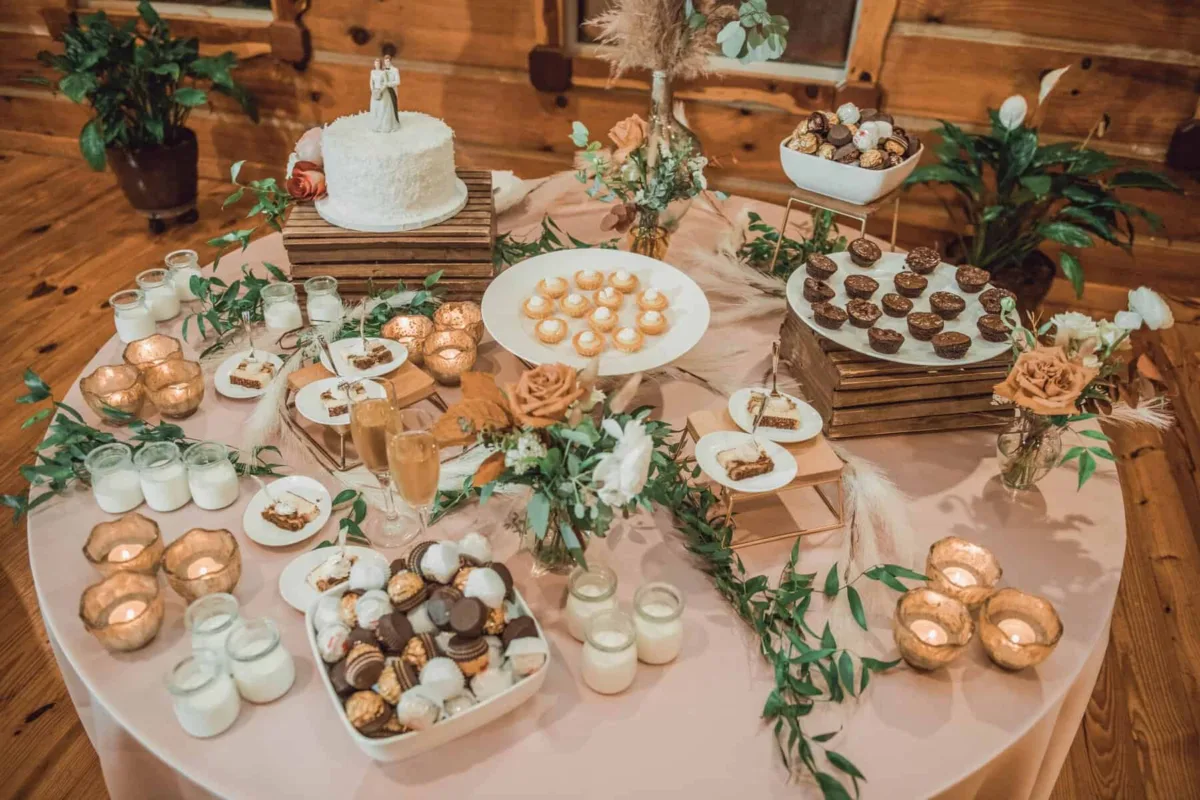 nashville wedding dessert table a catered affair rustic venue - Desserts Elegant wedding dessert table by A Catered Affair featuring wedding cake, chocolates, and candles at rustic Nashville venue