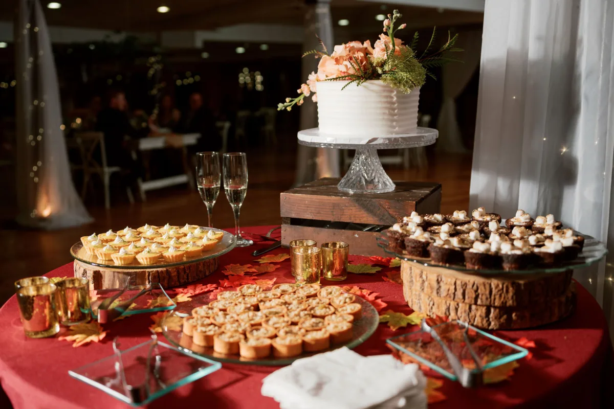 nashville wedding dessert table catered affair planning - Desserts Elegant wedding dessert table with white cake, champagne flutes, and assorted sweets created by A Catered Affair in Nashville