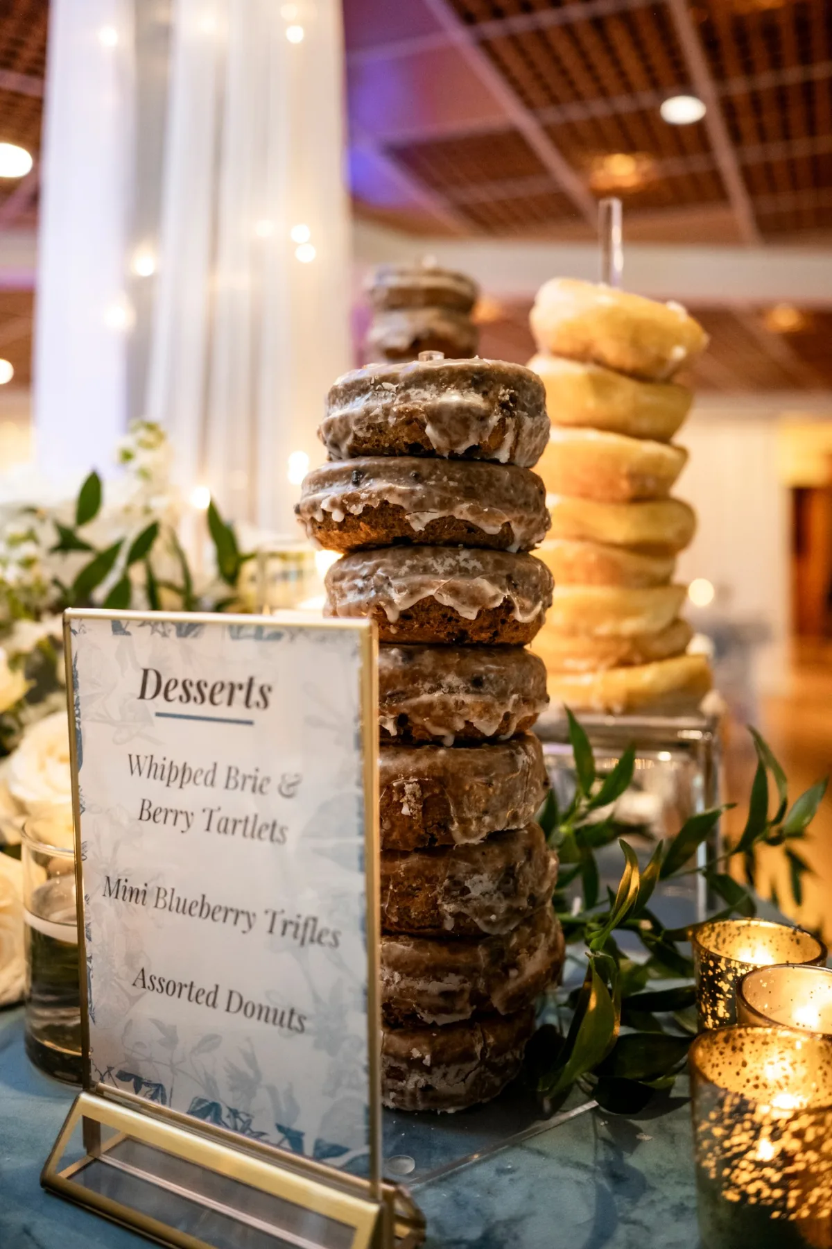 nashville wedding dessert table donuts a catered affair - Desserts Elegant wedding dessert table featuring stacked glazed donuts with menu card by Nashville caterer A Catered Affair